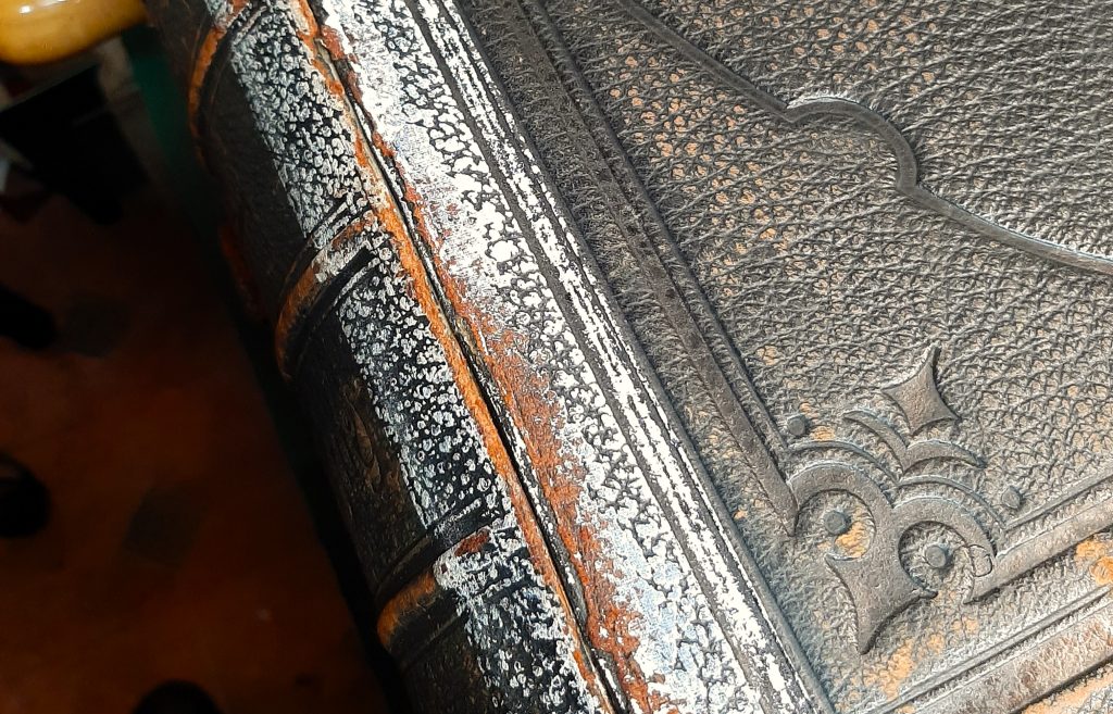 Family Bible showing white residue on the cover from removed duct tape