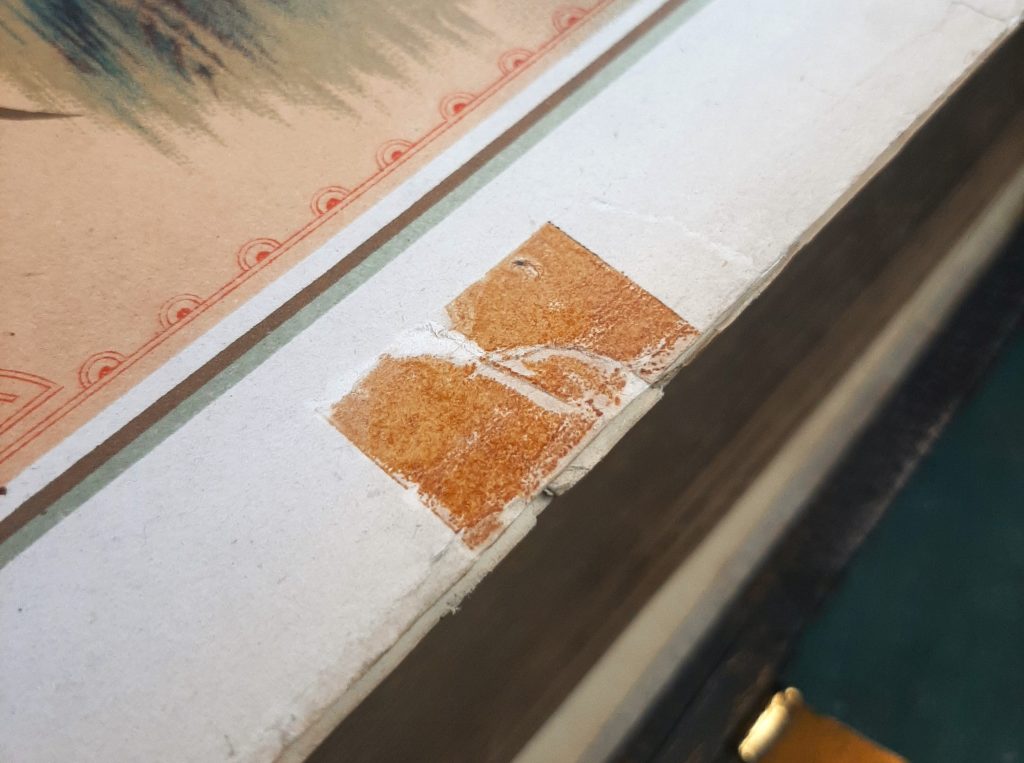Bible page with orange remnants of sellotape repair