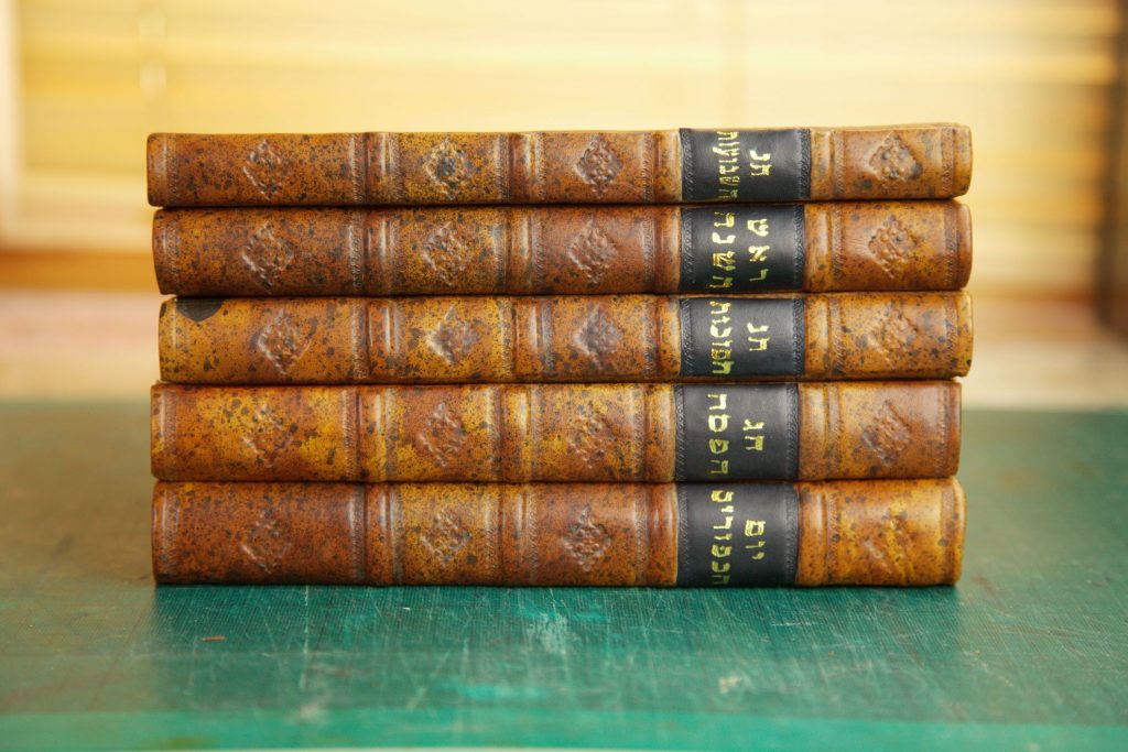 Antique Jewish holy day books with new leather spines black and gold spine labels